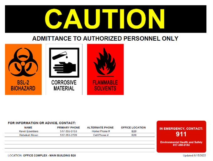 Laboratory door sign with BSL-2 hazard label, corrosive material hazard label and flammable solvents hazard labels. Sign also includes laboratory contact information and emergency contact information.