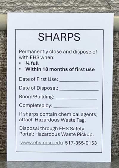 Photo of the required label on a sharps disposal container. Storage limit has been updated from 90 days to 18 months.